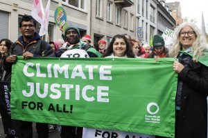 Activists with climate justice banner at COP23 climate demo