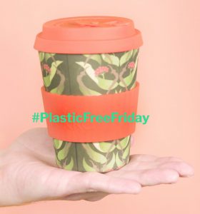 Reusable coffee cup on a peach background