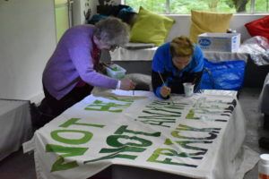 Campaigners painting an anti-fracking banner