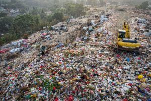 Excavator in waste mountain, Indonesia.
