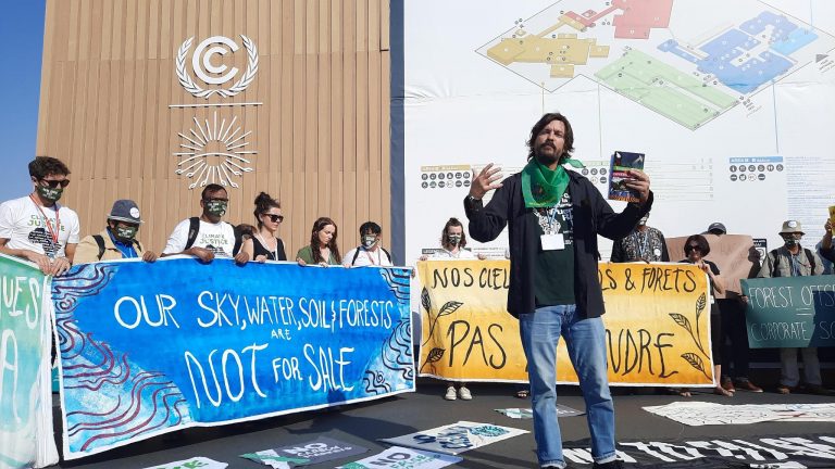 protestors in front of banners at COP27