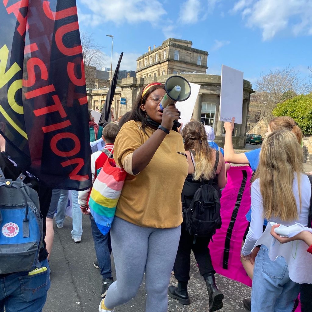 a young woman shouting through a megaphone