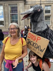Two women with a large papier mache Jackdaw