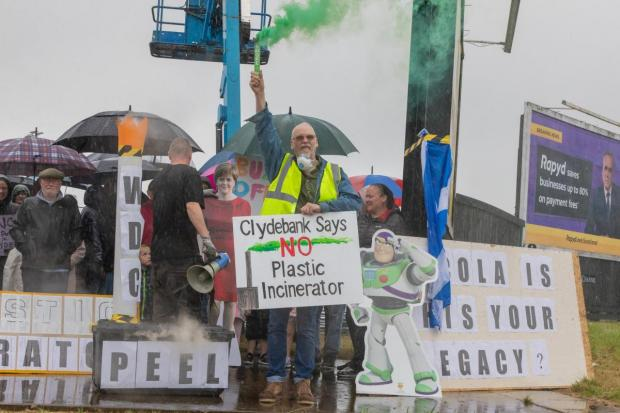 Group of people gather together with signs including 'Clydebank say no plastic incinerator'