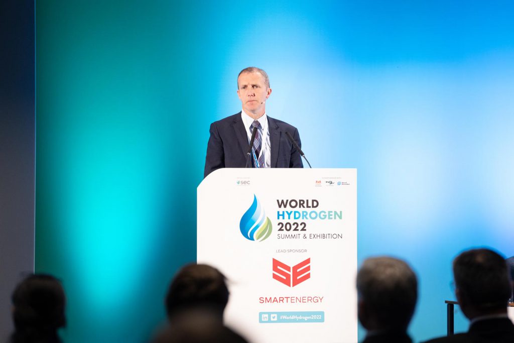 Michael Matheson speaking to a conference from a podium emblazoned with "World Hydrogen 2022 summit and exhibition"