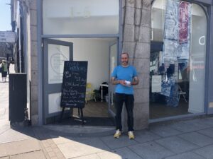 a man stands outside repurposed city centre retail location