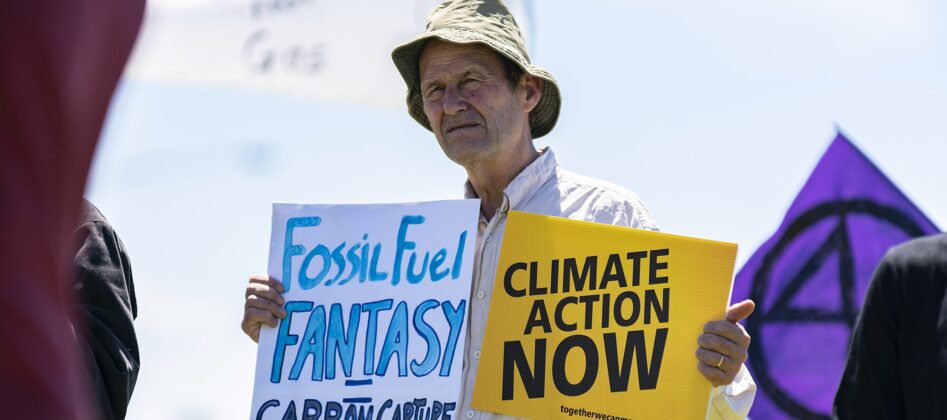 man holding two signs
