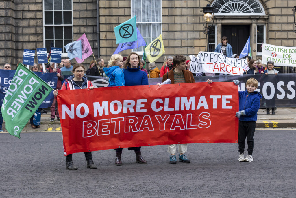 Protest group with banner in front of Bute House in Edinburgh