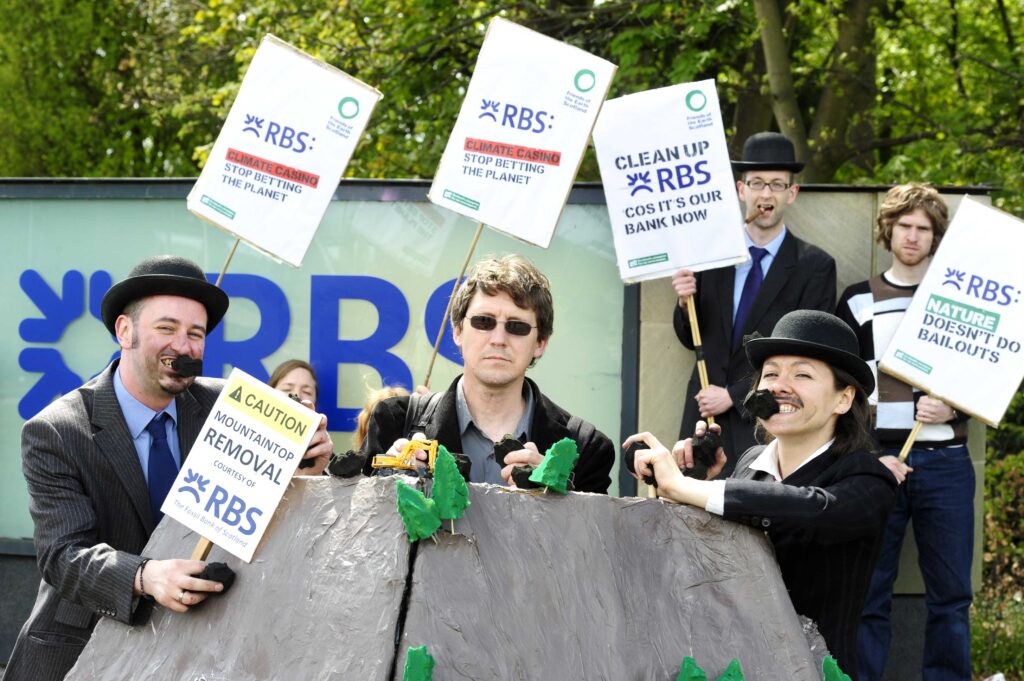 People hold anti-RBS placards infront of their HQ