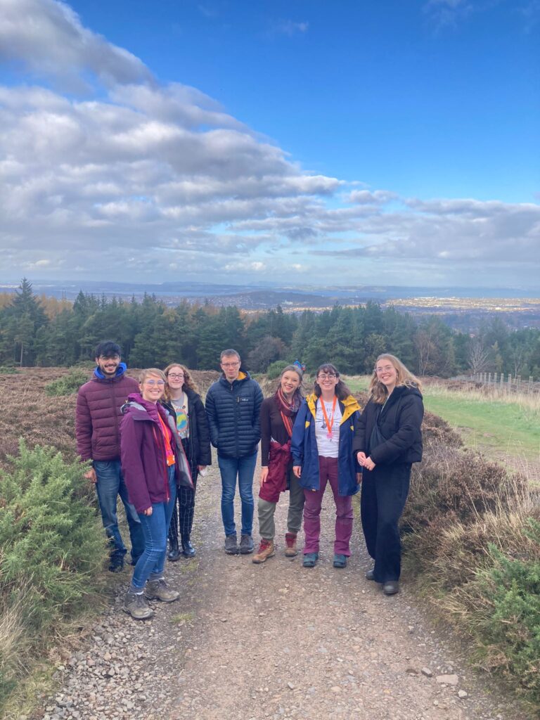 a group of young people outside on a hillside