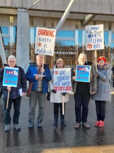 A group of protestors holding placards against the incinerator outside the Scottish Parliament