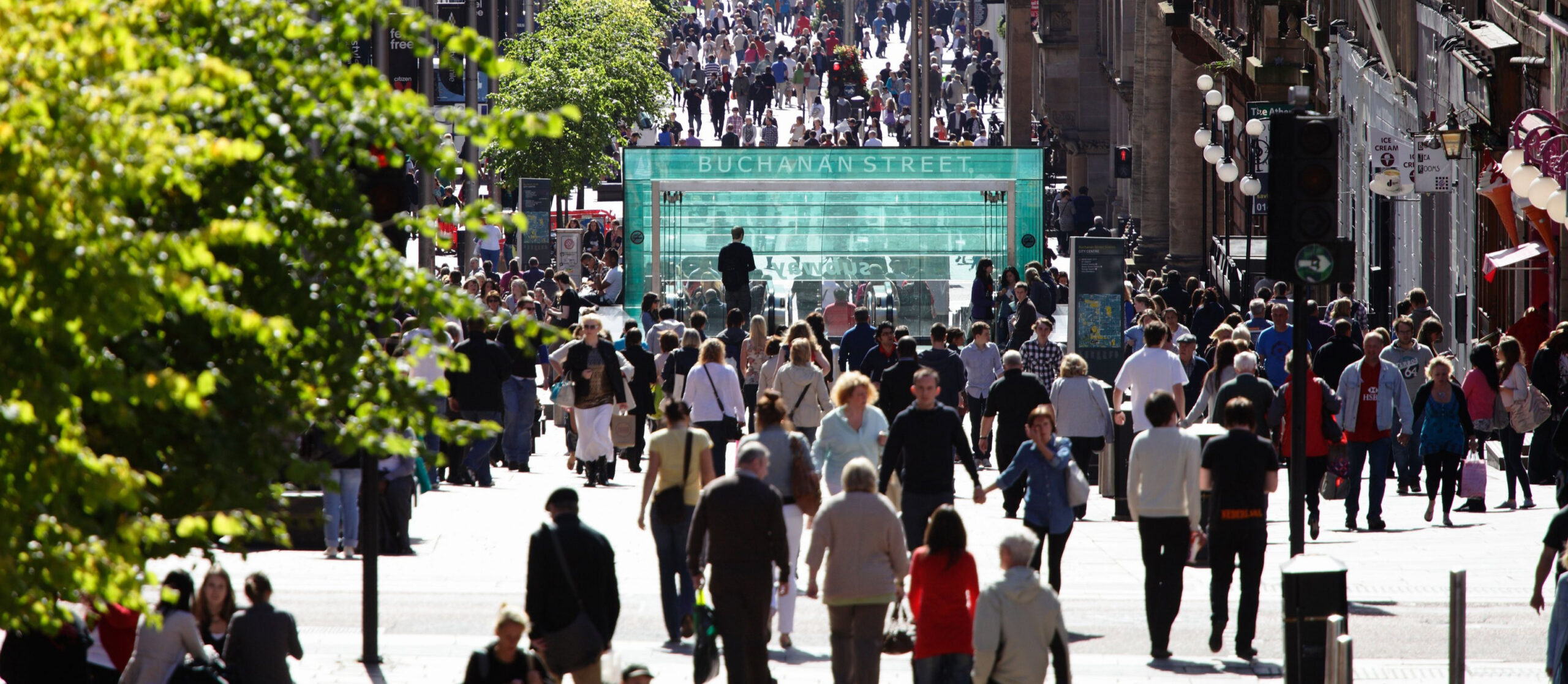 Buchanan Street, Glasgow city centre, people walking in summer sun,