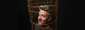 stu goldsmith head in a bird cage